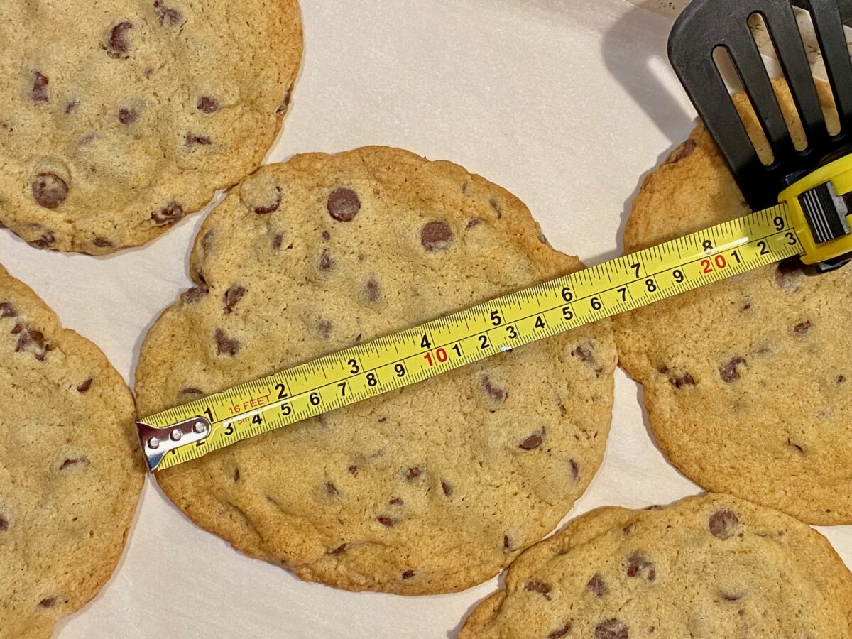 picture of a monster chocolate chip cooking with a tape measure across it measuring 6 ½ inches wide.