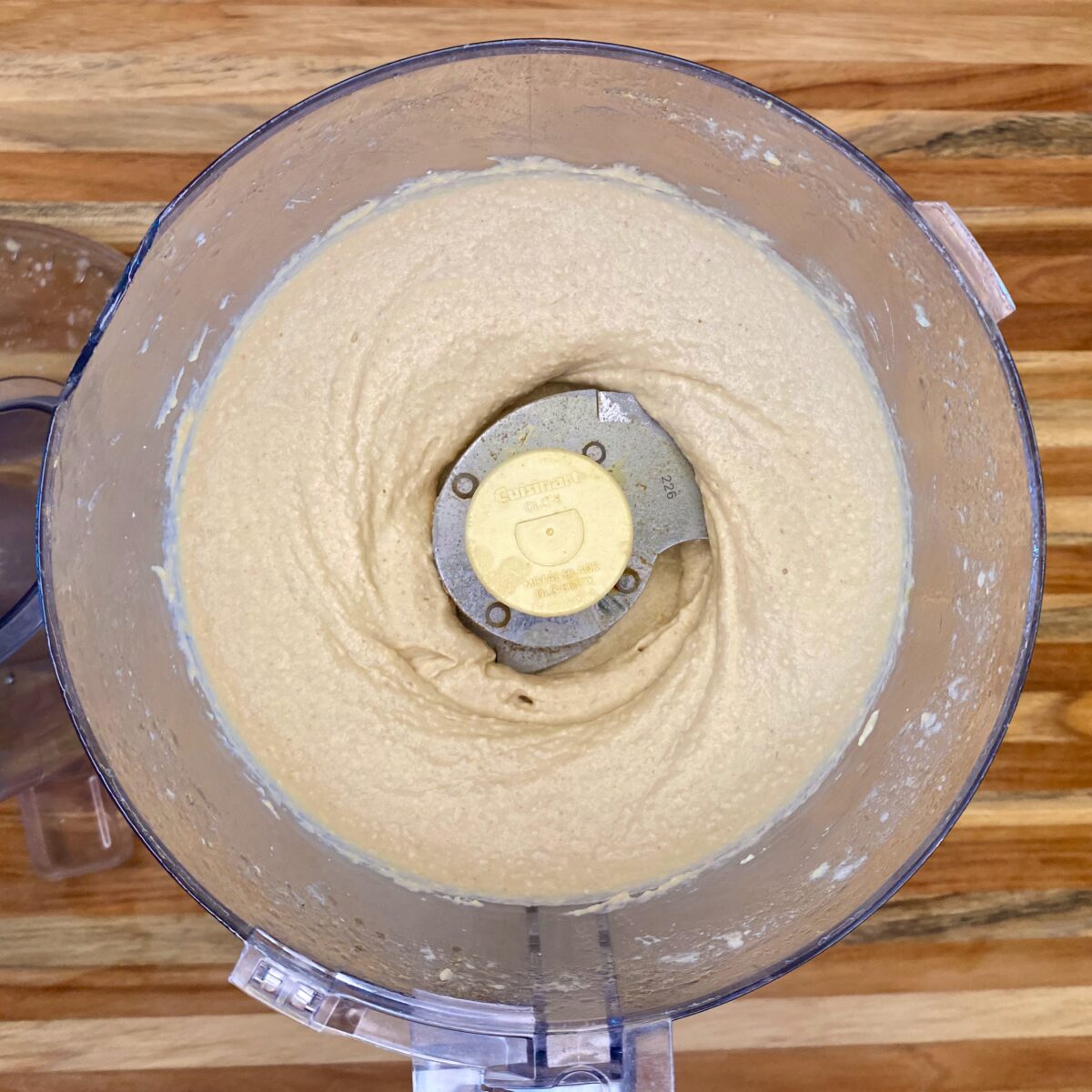 After 2 minutes of processing, the hummus is starting to look creamy.