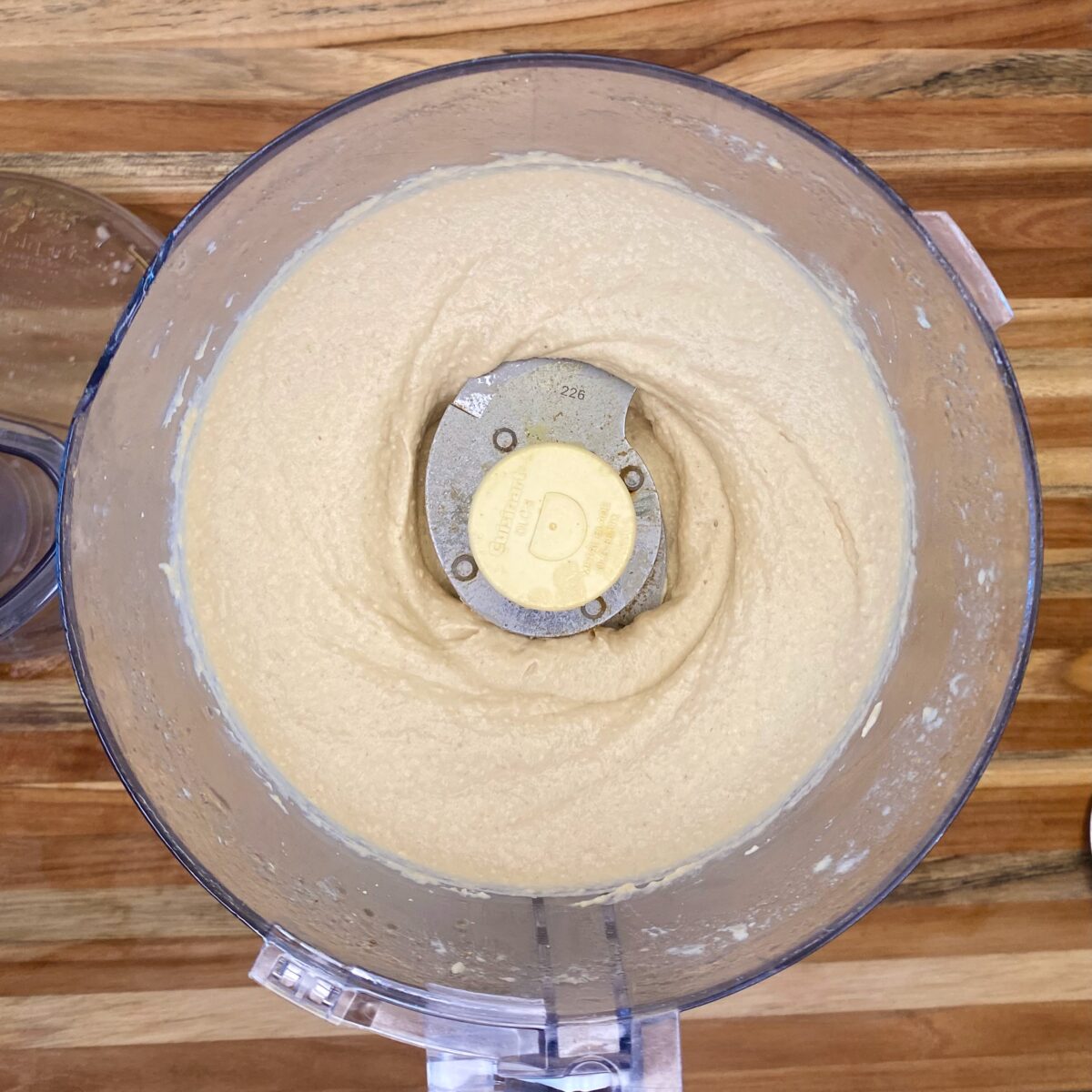 After three minutes of processing, the hummus is smooth and creamy, and ready for a flavor check.