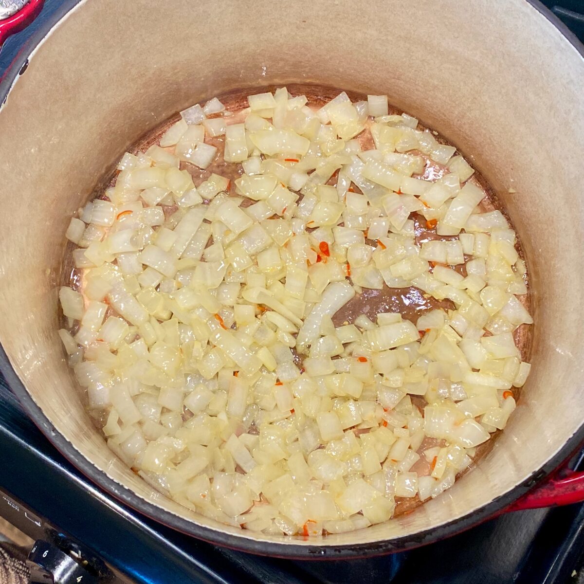 Softened onions and Thai chili sauteing in the Dutch oven.