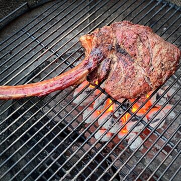 Tomahawk steak over red hot charcoals