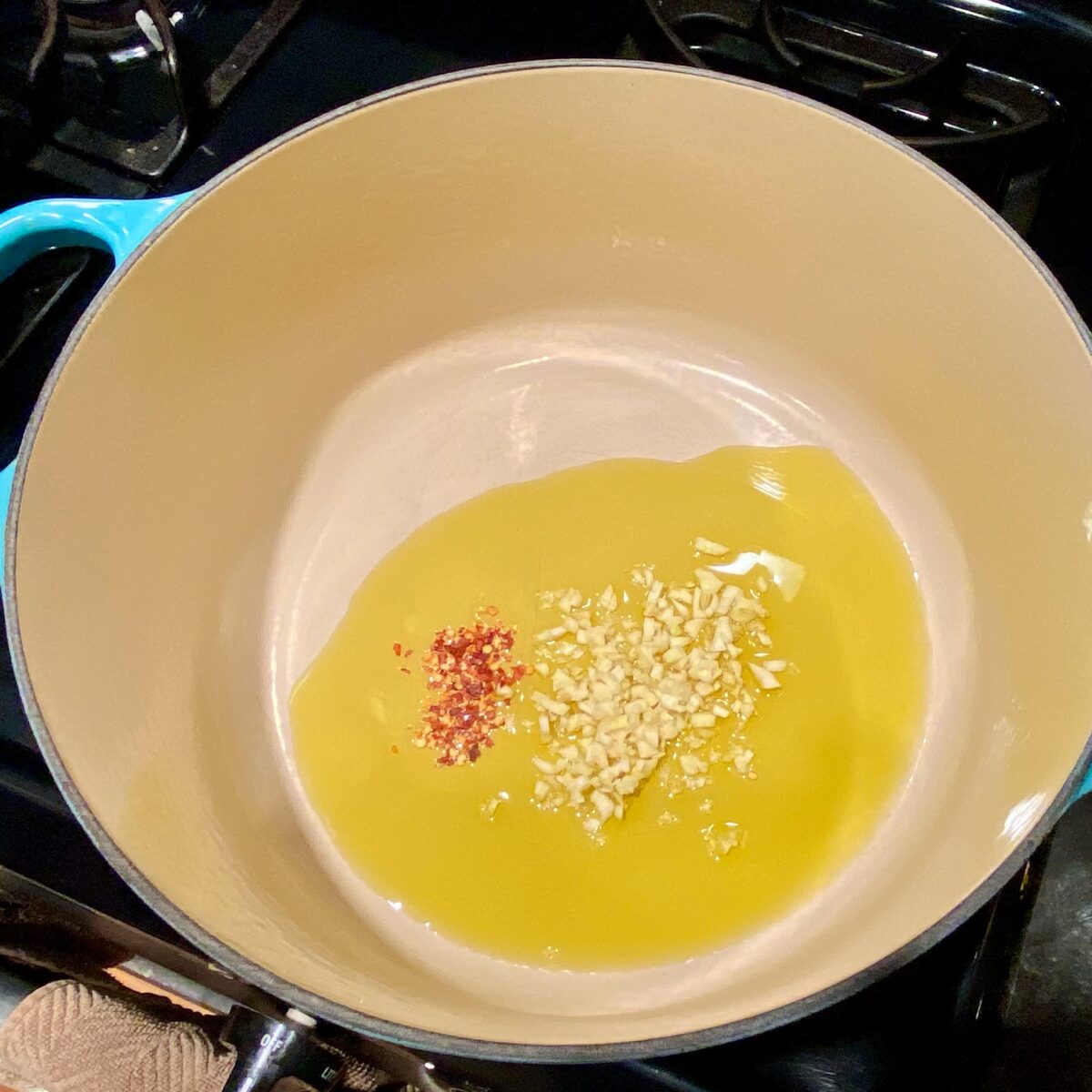 Pepper flake, garlic, and olive oil, starting from room temperature, and slowly heating.